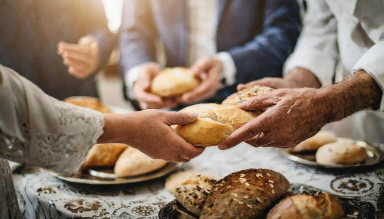 unity and spirituality as people share communion, breaking bread together